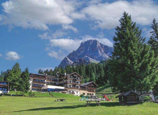 Hotel circondato da montagne e alberi.