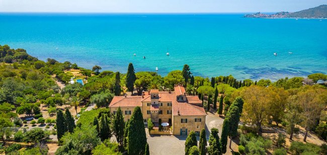 Villa circondata da alberi vista mare.