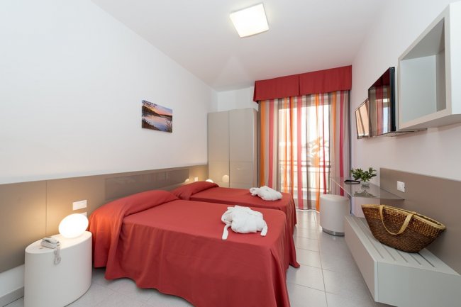 Camera doppia con letti rossi.