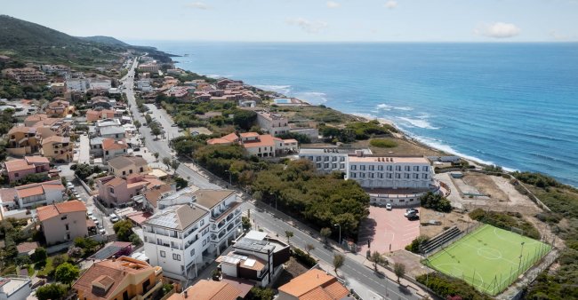 Veduta aerea di una città costiera e strade.